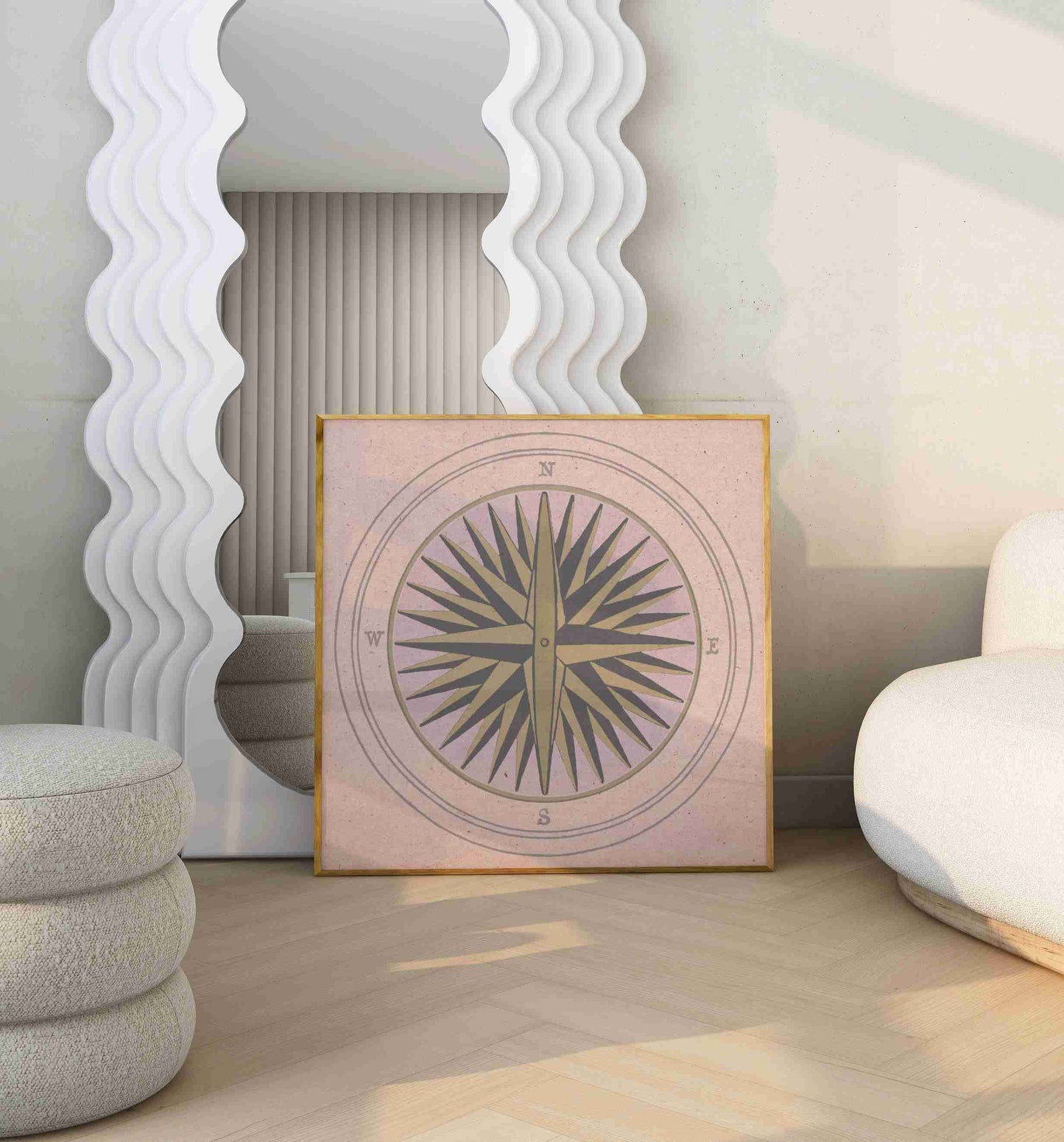 Poster with an illustration of a wind rose stands in a modern room with sofa and big mirror.