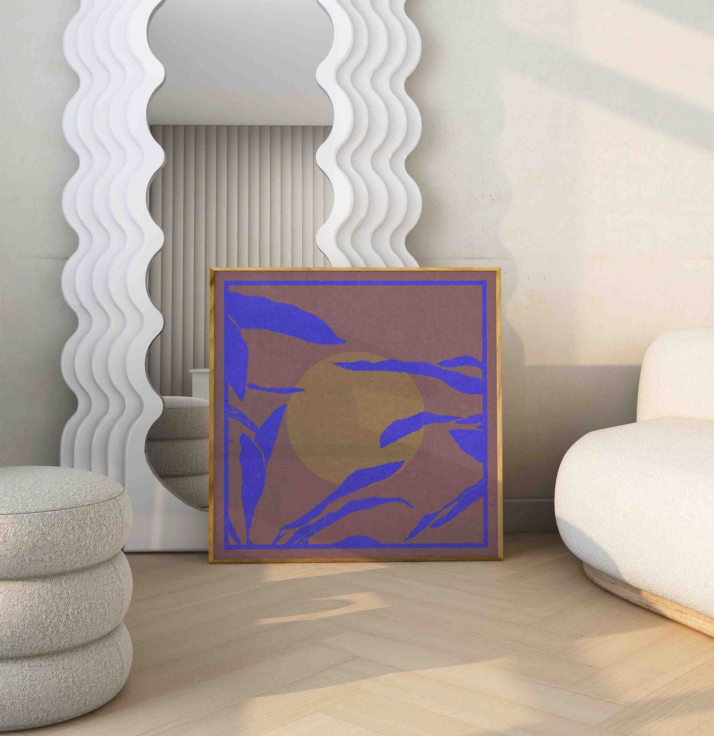 Framed poster with a floral motif in blue, brown, and mustard colors stands in bright room