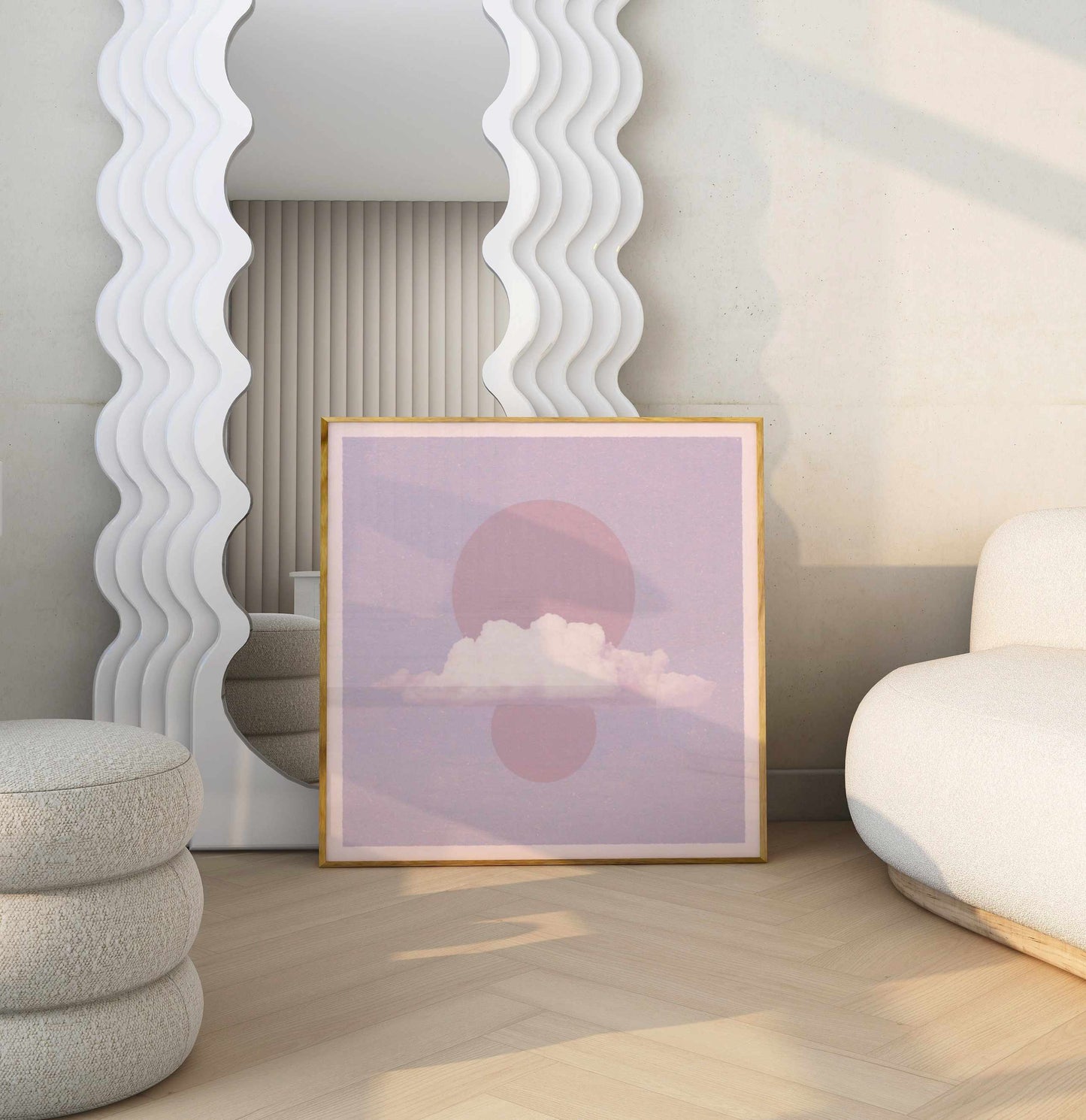 A poster in shades of pink in a room with cream furniture and a large white mirror