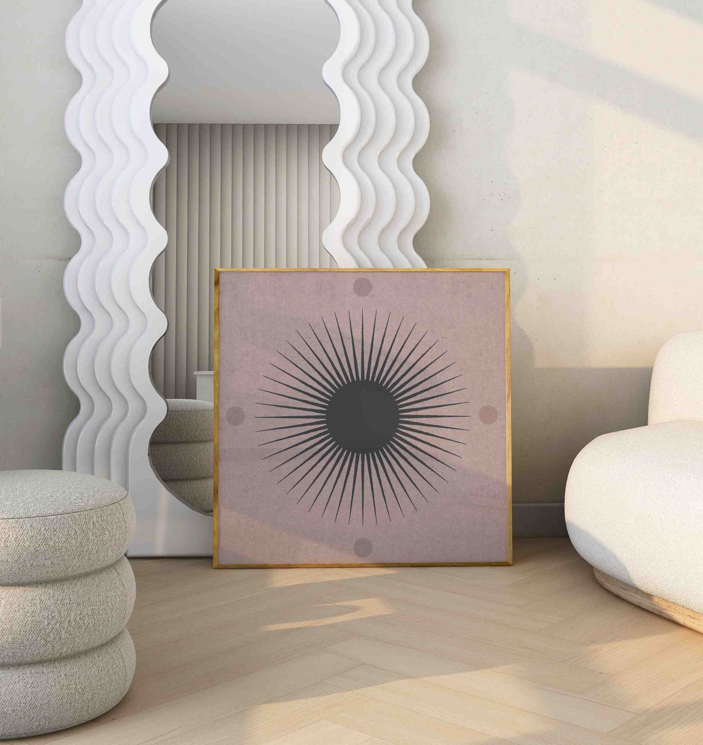 A poster with an illustration of a sun motif stands in a room with a white sofa and a big mirror